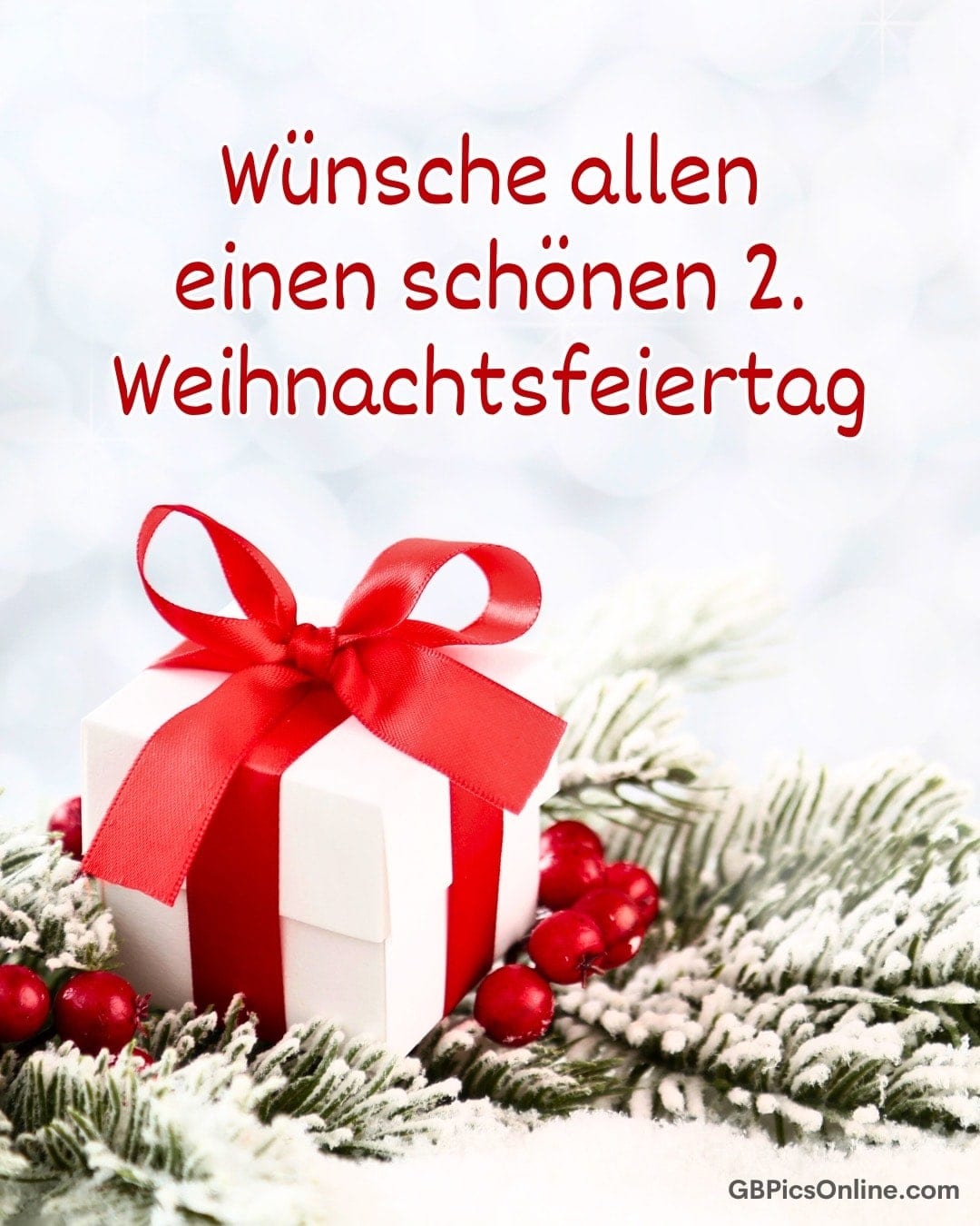 Wünsche allen einen schönen 2. Weihnachtsfeiertag. Geschenk mit rotem Band liegt auf verschneiten Zweigen