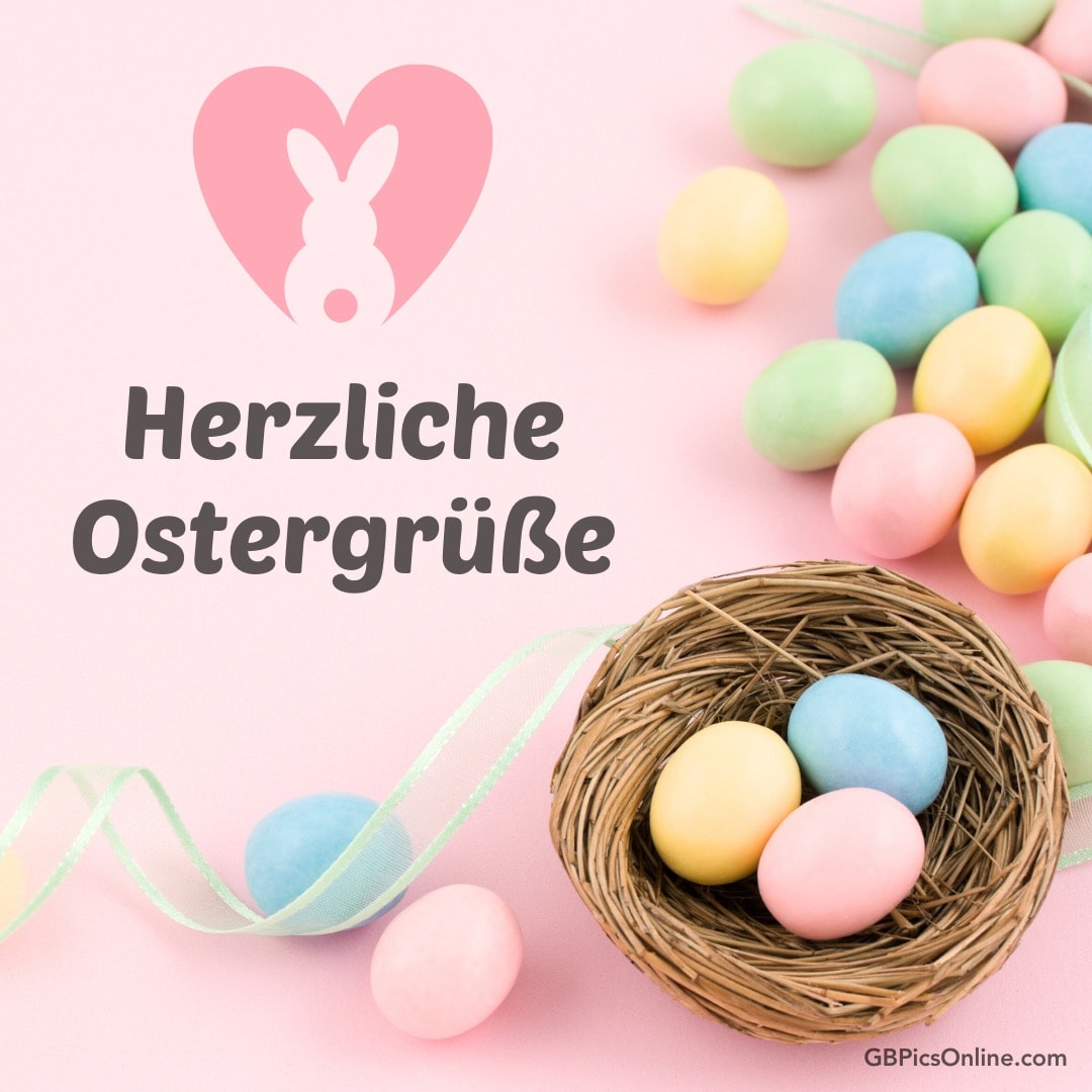 Bunte Eier, Nest und „Herzliche Ostergrüße“ auf rosa Hintergrund