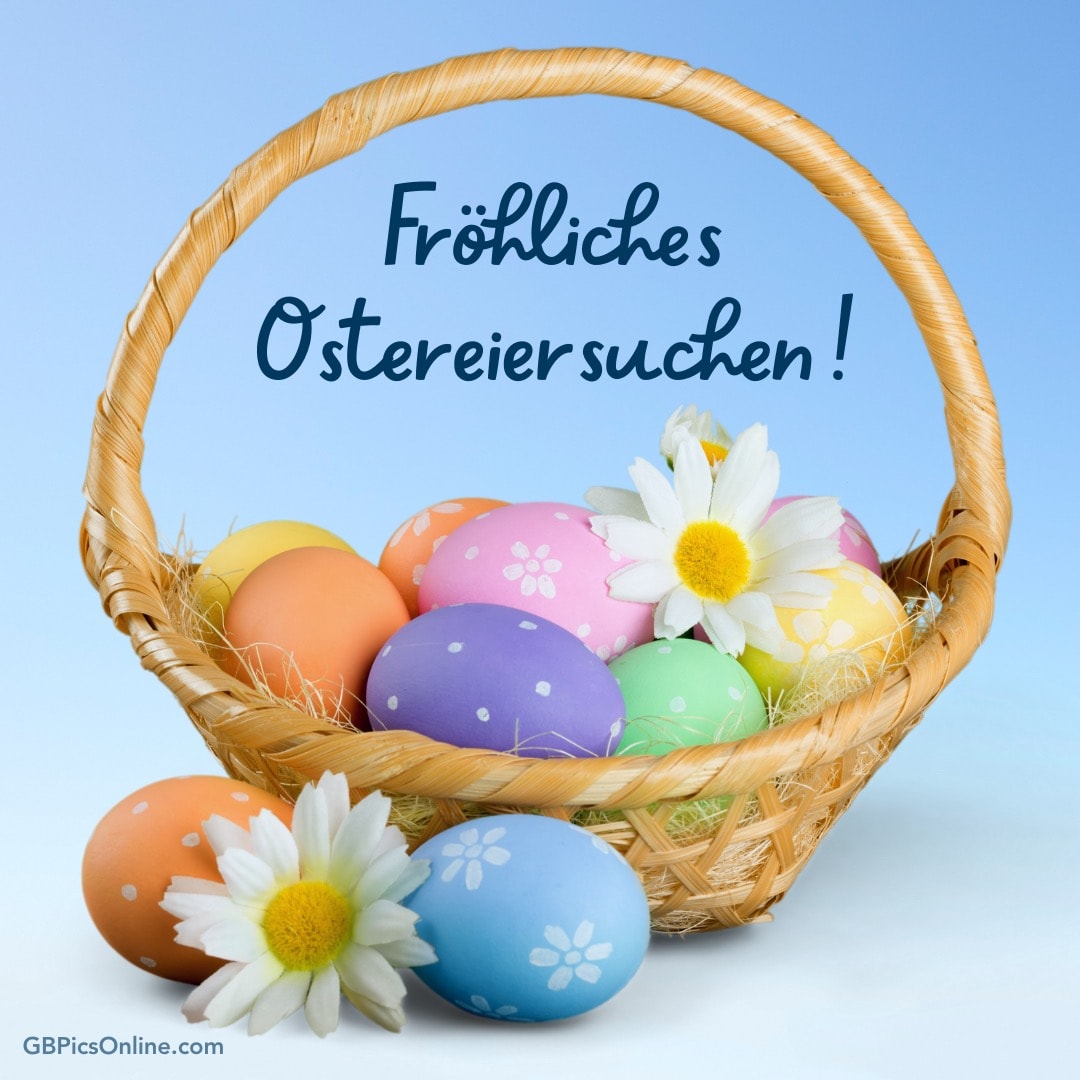 Ein Korb mit bunten Ostereiern und Blumen. Text: „Fröhliches Ostereiersuchen!“