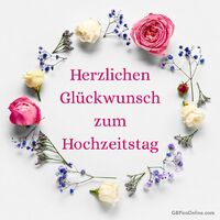 Ein eleganter Blumenkranz bildet den perfekten Rahmen für romantische Hochzeitsgrüße.