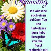Bunte Blumen mit Schmetterling; daneben Grußtext zum Samstag auf hellblauem Hintergrund mit Herz