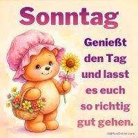 Niedlicher Teddy mit rosa Hut hält eine Sonnenblume und einen Korb mit Blumen, dazu Sonntagsgruß