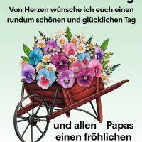 Grußtext zum Donnerstag und Vatertag über einer Schubkarre voller bunter Blumen
